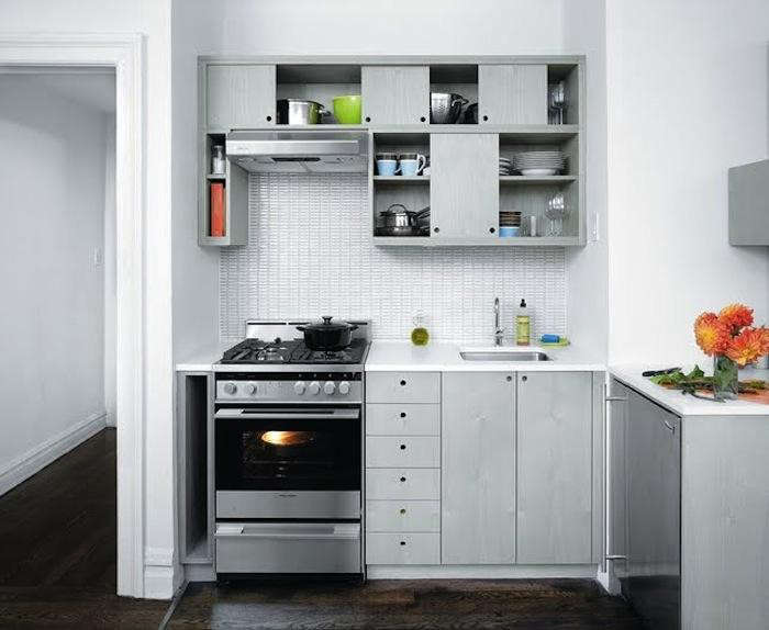 The Sliding Kitchen by Workstead, a member of the Remodelista Architect & Designer Directory, features circular cutouts in the cabinetry.