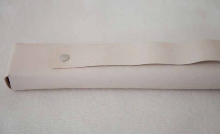 Step 4: Flip over the block to the display side. To create the knife holder, cut a strip of leather that is about one-inch thick (or adjust as desired; leave extra length so that there’s room for error). Pin down one end of the strip in the center of the block about an inch from the end.