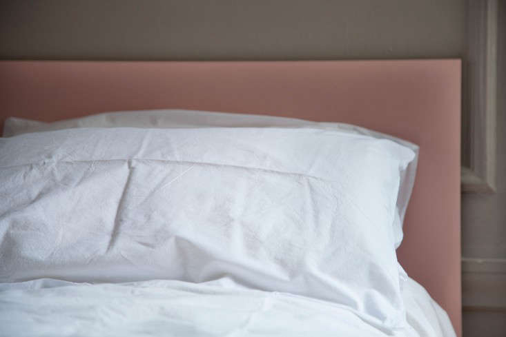 The board fits perfectly behind a layering of pillows and provides a finishing touch to the platform bed.