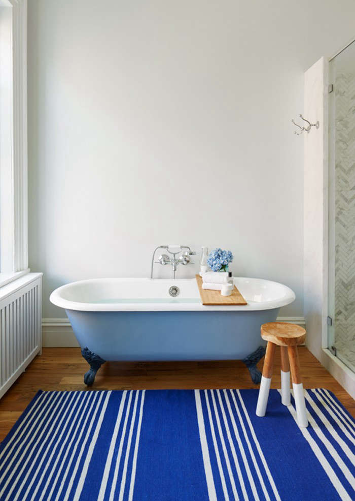 A bold statement in a Brooklyn bath. We like how the large-scale rug serves both bath and shower. See A House United: Reimagining a Brooklyn Brownstone.