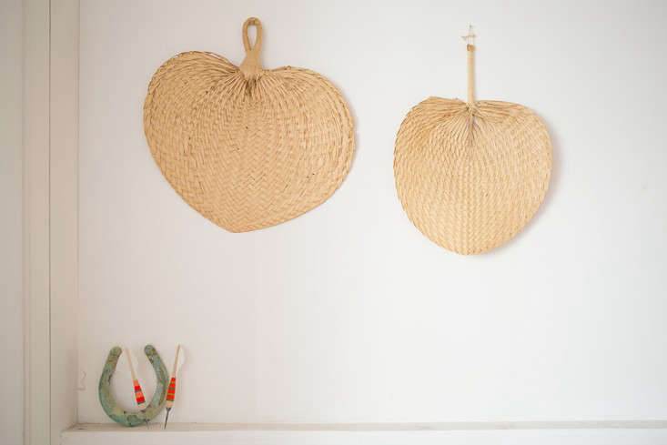 A corner of the room is decorated with straw hand fans and Fredericks & Mae Darts (the dart bodies are made by US manufacturer Apex; Gabe hand-finishes them with colored thread and fletching).