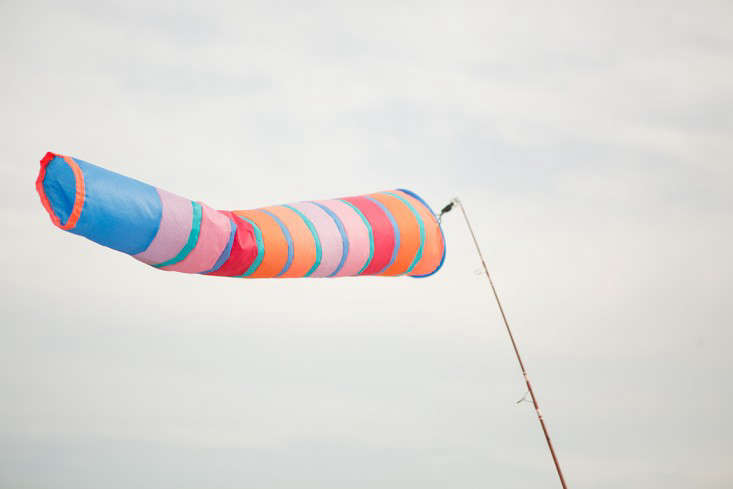 A Fredericks & Mae windsock flies from a fishing rod.