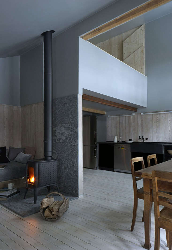 Bundle up after hitting the slopes—or just against the cold winter weather—with a fire in the fireplace or wood stove, as the Swiss do. Add Swiss specialities like raclette and chocolate accordingly. Photograph by James Brittain Photography from Swish Chalet: An Alpine Remodel by Jonathan Tuckey.