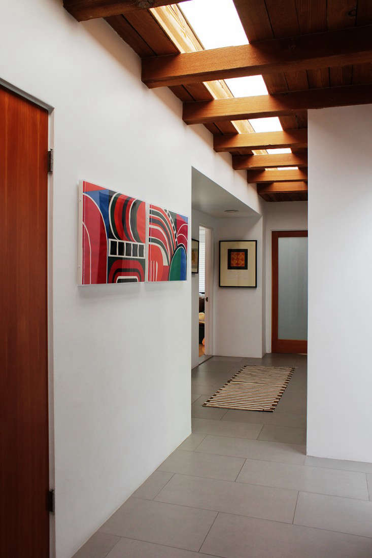 The hall is lit by a long, narrow skylight original to the house.
