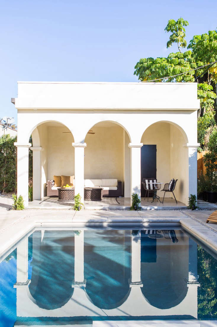 The pool house is designed for lounging and has a small bathroom. COME SEE MORE Rustic Spanish Villa Interior Design Inspiration!