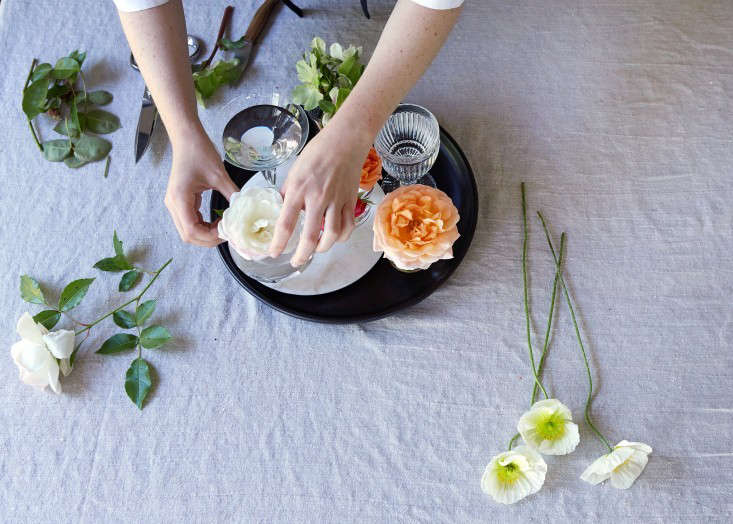 A floral arrangement in cocktail glasses. Photography by Aya Brackett for Gardenista.
