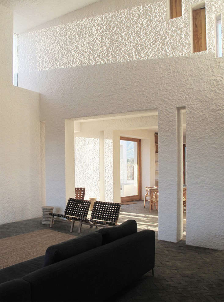 The Architect Is In A Passive Solar House For Family Of Unfolds In The Living Spaces Where Finish On Walls Is Same Limewash Rough Cast Plaster That S Exterior Dark Bricks Are Laid