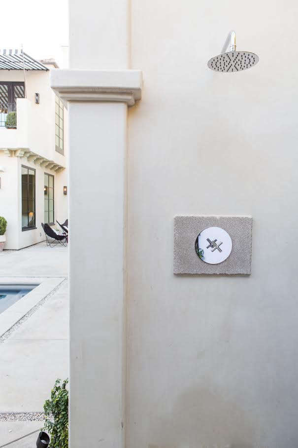 In Leigh Herzig's Spanish villa in Hollywood, an outdoor shower with a Rainfall Showerhead from Signature Hardware.
