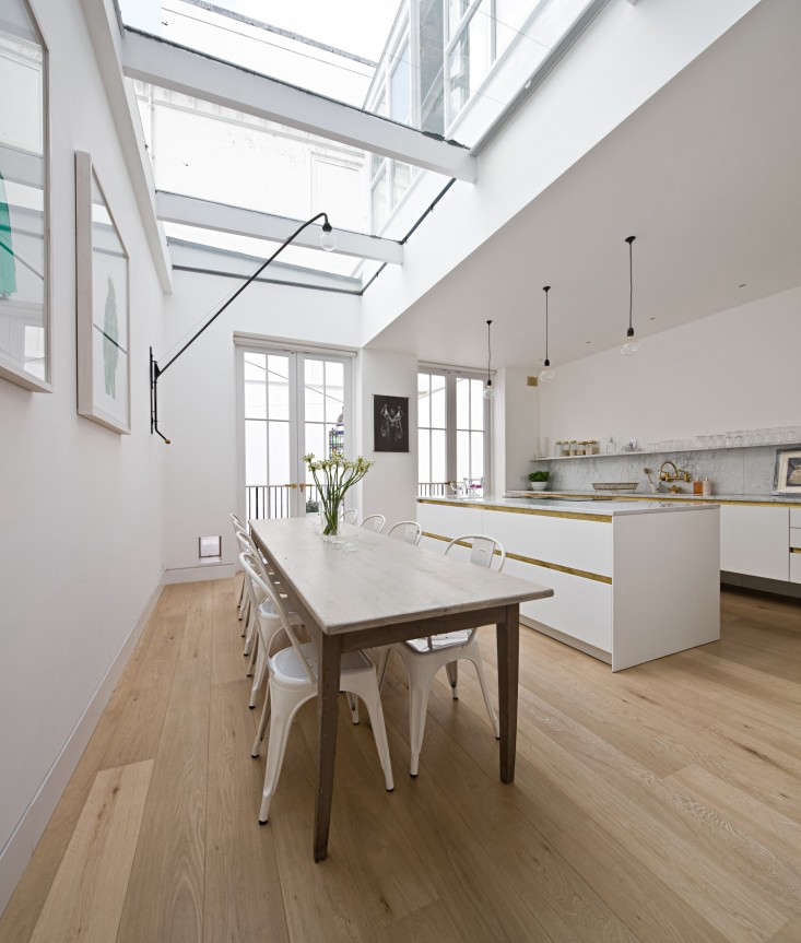 In the airy atrium-like dining area, Anstruther used a suite of powder-coated Tolix Marais Chairs ($295 each from Design Within Reach).