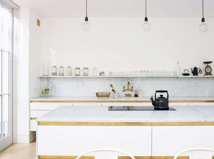 Anstruther used Bulthaup b1 Kitchen Units and added custom brass strips to echo the brass faucet.