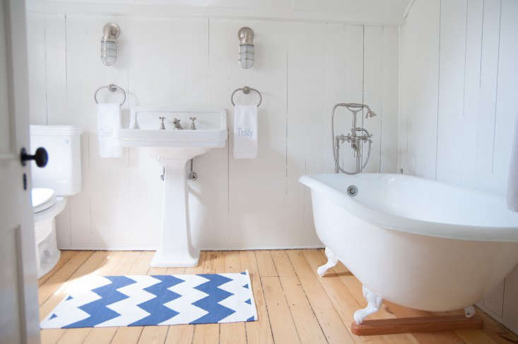 Stripes gone haywire: In Before & After: A Summer Cottage Reborn on the Connecticut Coast, a chevron mat plays on the classic blue-and-white-striped cottage rug.