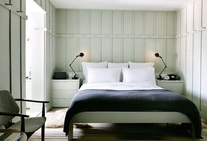 Black Jielde reading lamps flank the bed in London’s High Road House; see High Road House in London Gets a Revamp.