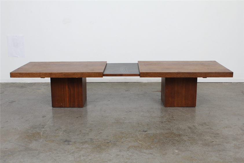 This John Keal Expanding Coffee Table is made of walnut and black laminate. It