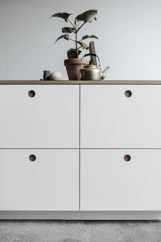 A Sixties-Inspired Danish Ikea Hack, Now Coming to America, includes subtle circular cutout pulls.