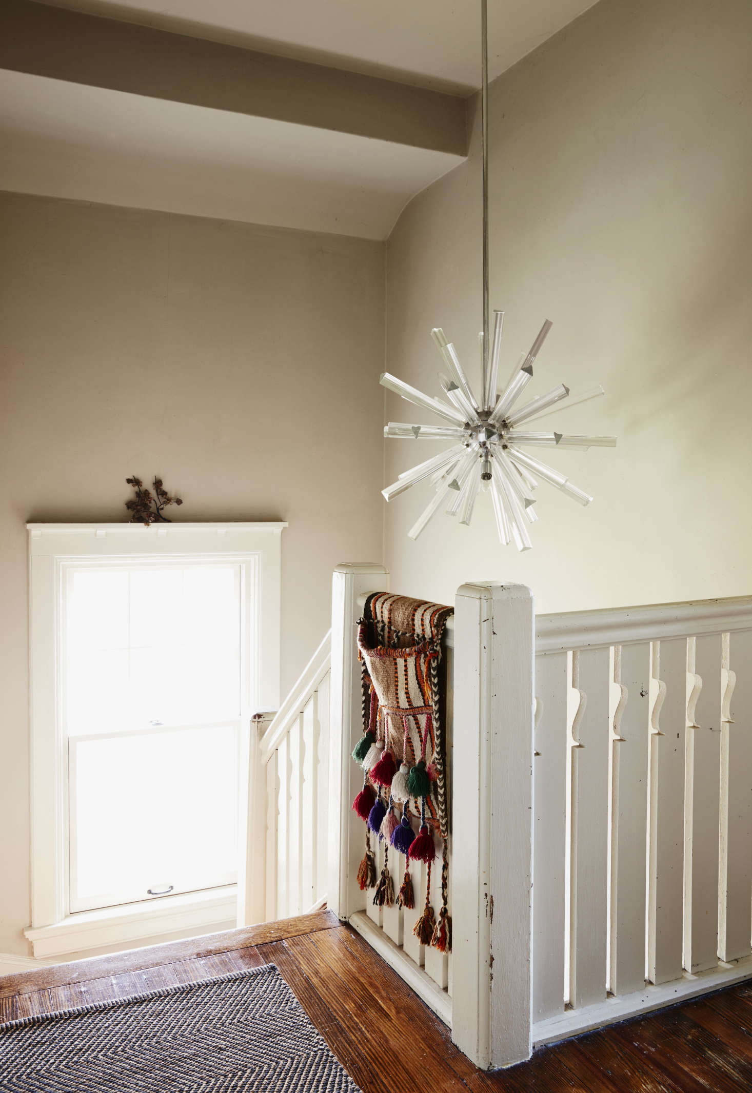 The upstairs landing is hung with a 1960s Murano glass fixture that Danny got from a client who was getting rid of it. The tasseled saddlebag came from Nine Streets New York, one of Livia’s favorite textile shops.