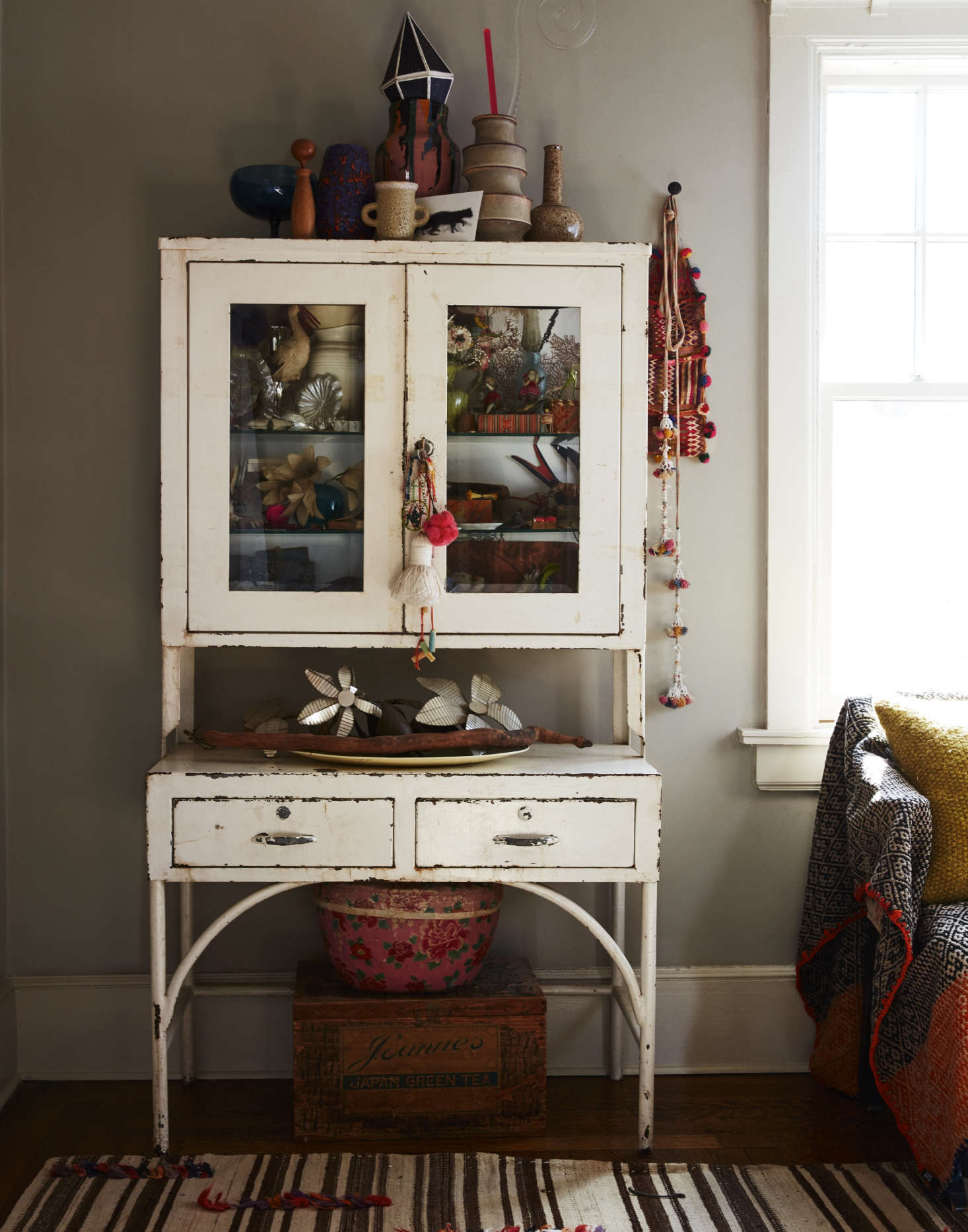 An old enameled dental cabinet is Livia’s curio case. The walls throughout are painted Pashmina in matte from Benjamin Moore Agora, a warm medium gray—”a perfect neutral that works well with both the modern and the antique,” says Livia. The moldings are in semigloss Jute, also from Benjamin Moore Agora.