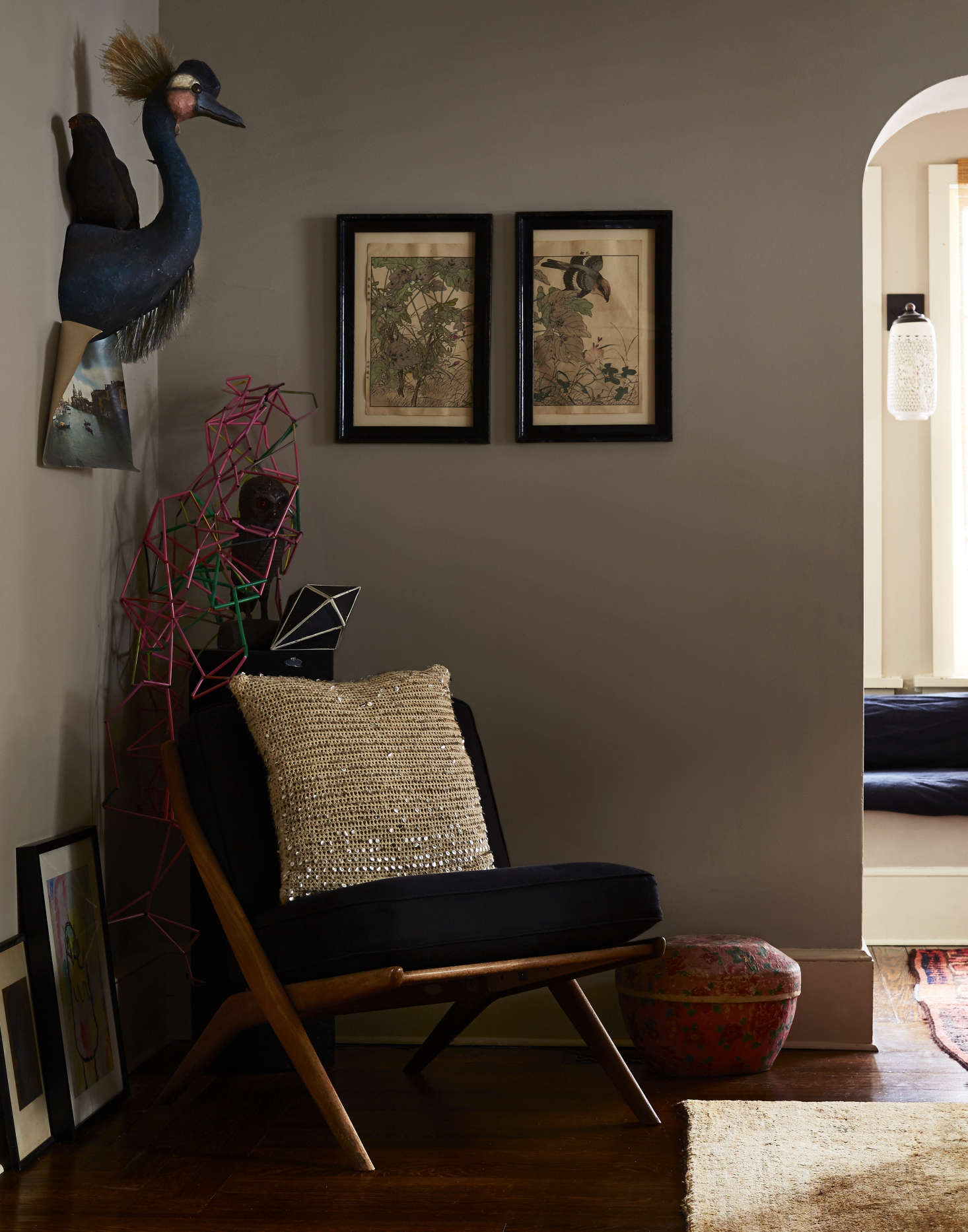 A Swiss sixties chair—a Riverdale trash day find—is propped with a pillow Livia made from a sequined sweater. The emu head is one of Cody Foster’s papier-mâché creations from John Derian.