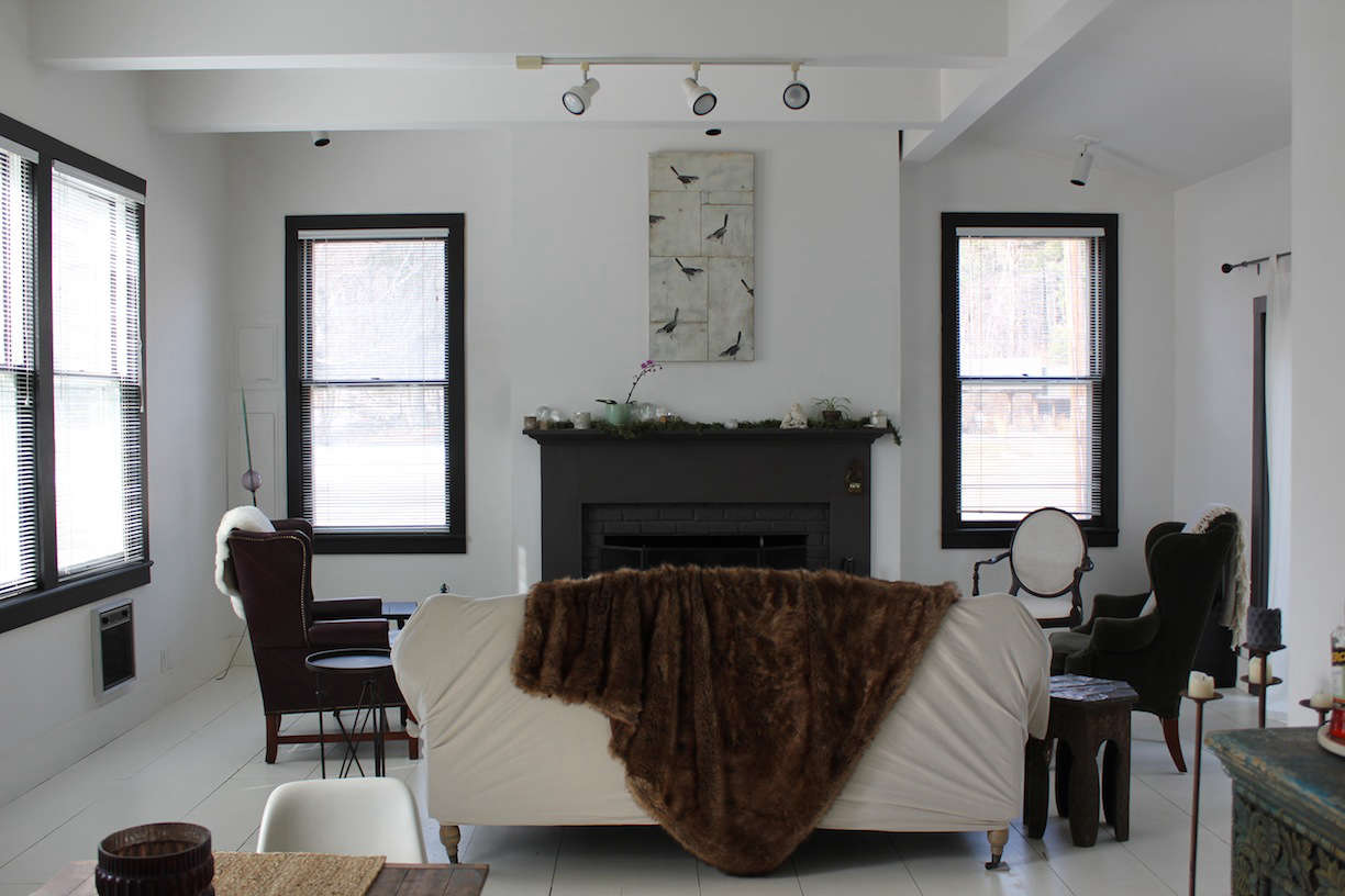 The interior of the cottage received a head-to-toe coat of white paint; window frames are painted black for contrast.