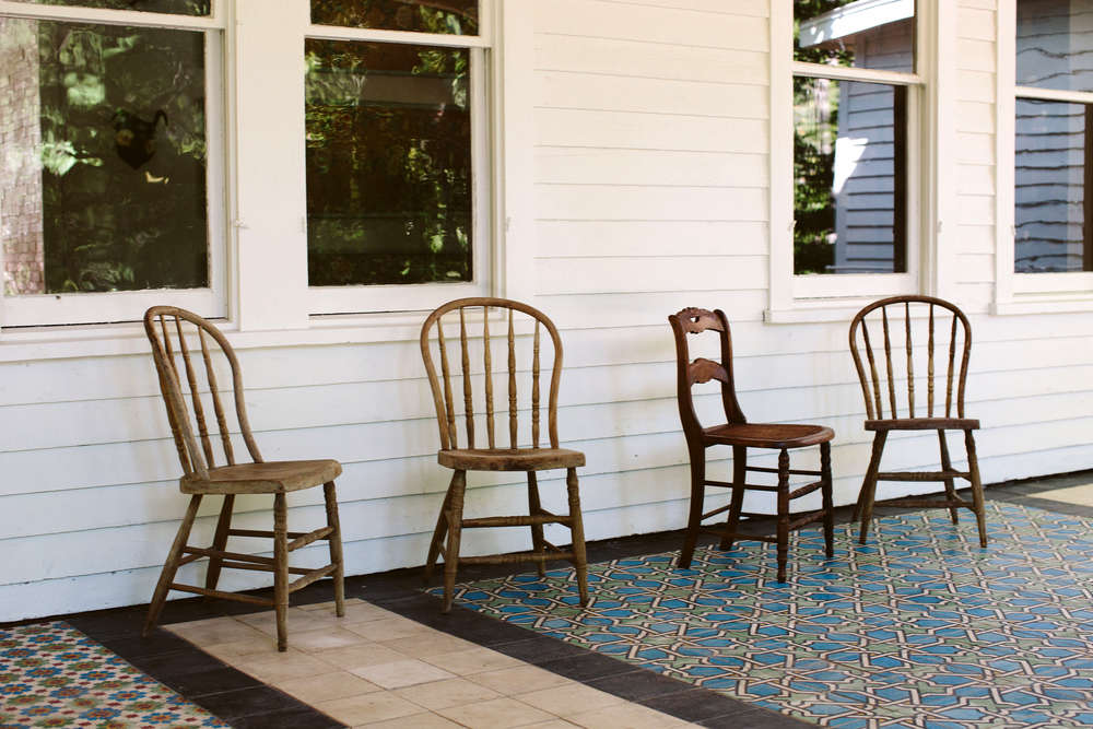 The porch is tiled in patchwork Moroccan tiles the owners found in a Brooklyn warehouse.