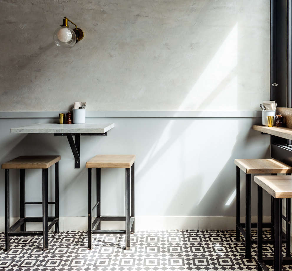 Graphic cement tile in black and white (it’s Granada Tile’s Fez) on the floor of Barzotto in San Francisco.