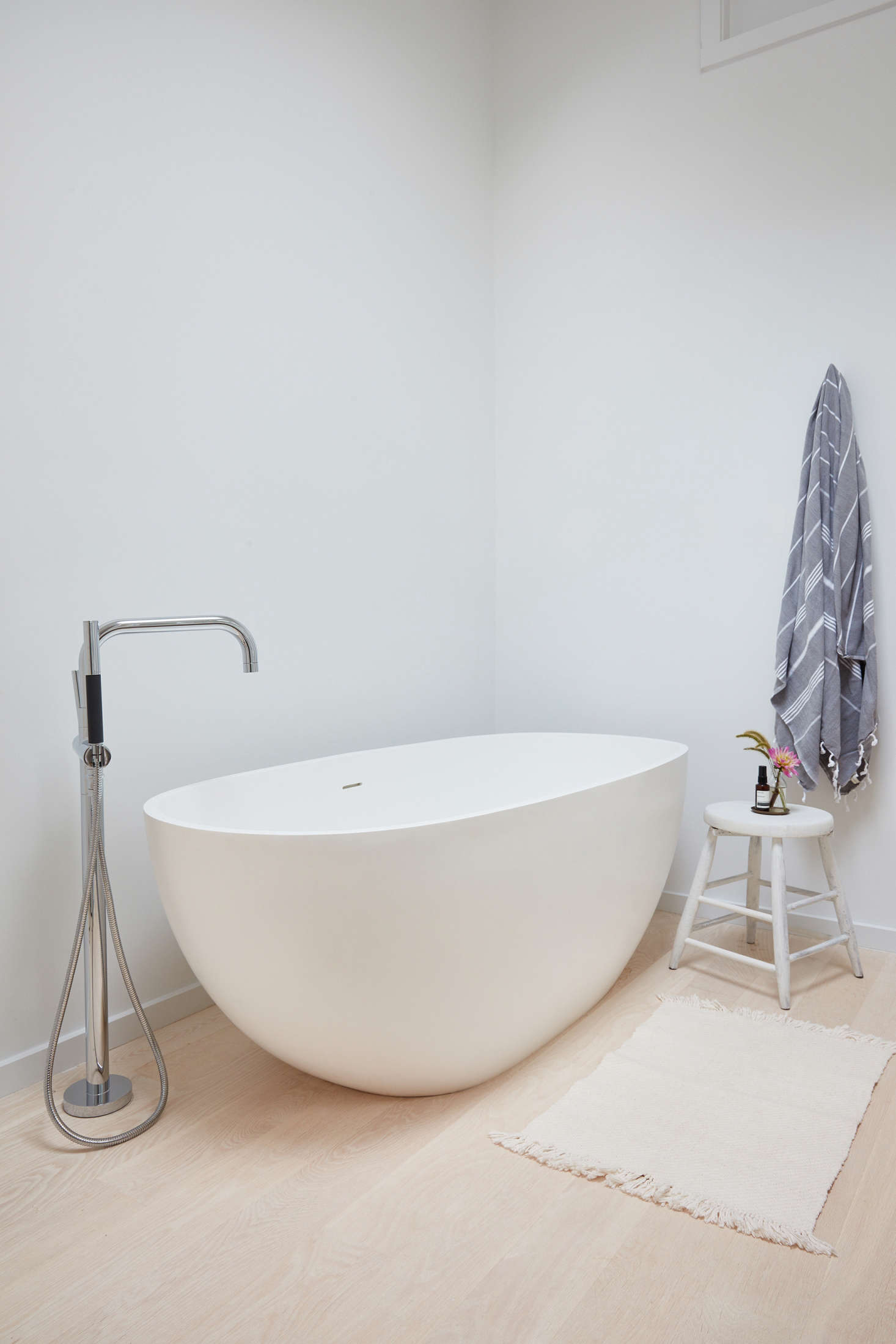 Also in the master bathroom, the ideal rejuvenation spot: a freestanding soaking tub from Signature Hardware is paired with a faucet from Kohler’s Purist collection. The white rug is from the Japanese site Analogue Life (similar options available).