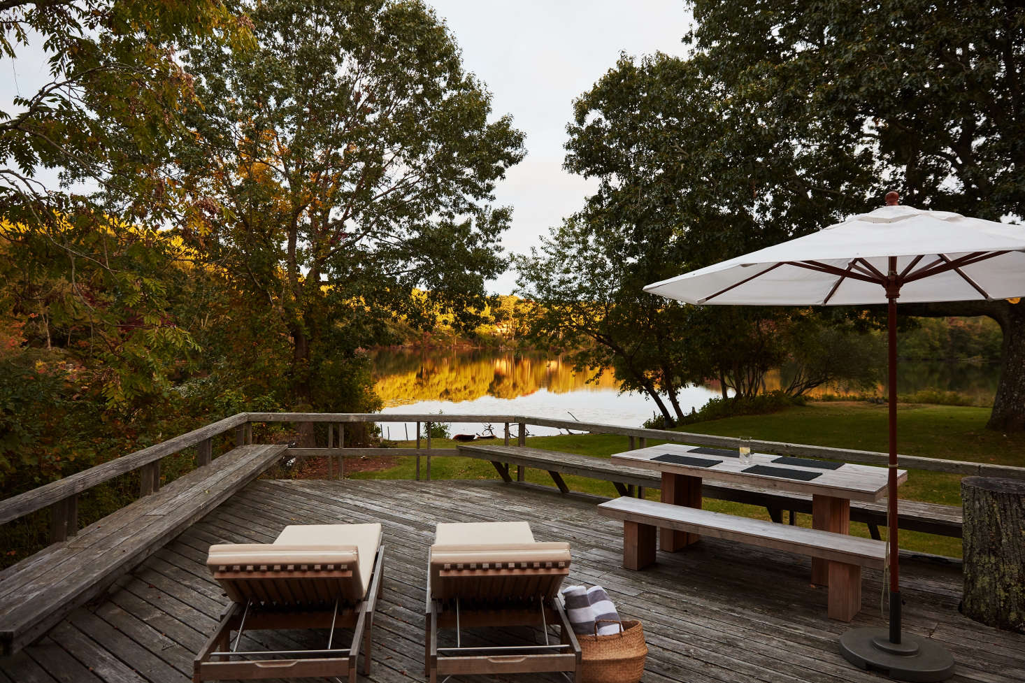 Jones kept the original weathered deck overlooking the lake, but added a two cream chaises from Skagerak (a similar option is available here), and a Vietnamese rice basket, ideal for carrying lakeside essentials, from Lantern Moon.