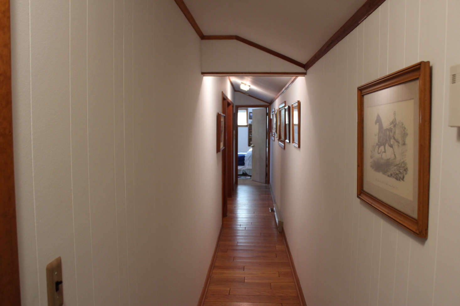 The hallway, pre-paint and concealed storage.