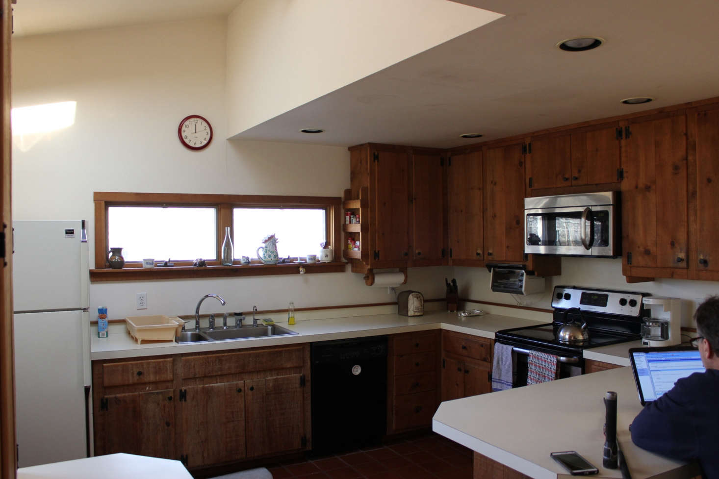The kitchen, as it was. Jones opened up the enclosed space and replaced the heavy, dark cabinetry.