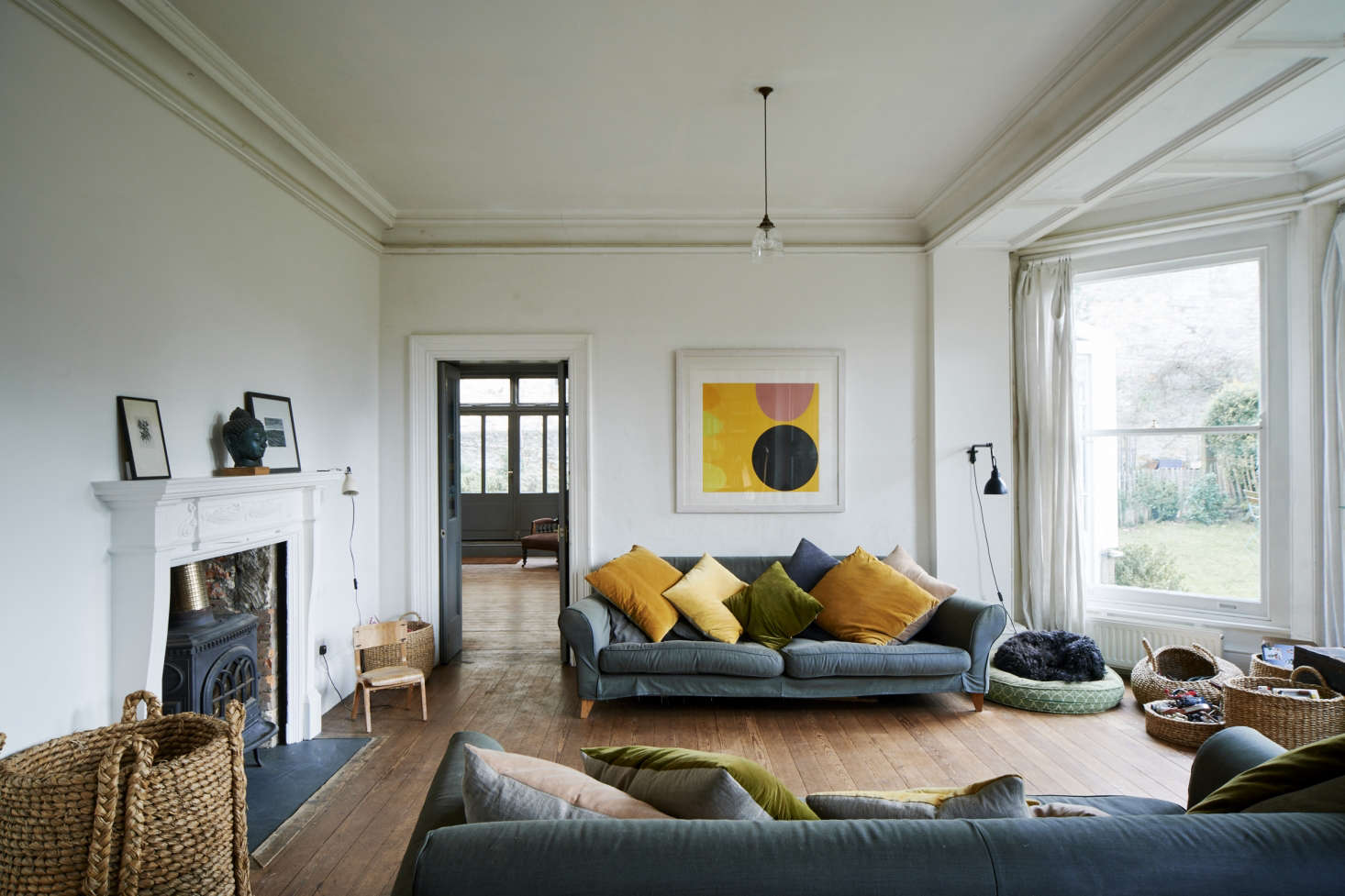 Kirsten Hecktermann’s hand-dyed pillows in the living room of designer Niki Turner’s house in Stroud, Gloucestershire.