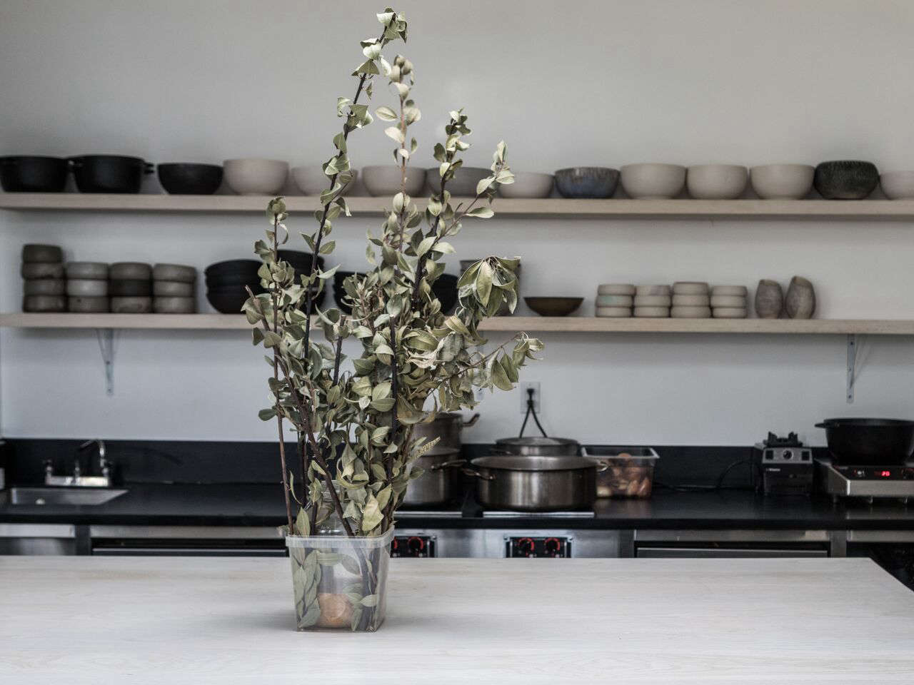 “One of my favorite parts of the kitchen is the dish station,” Kahn says. “We used industrial stainless steel shelves, and had them powder coated in matte white to match the white walls of the kitchen. From afar, the equipment looks as though it is floating.”