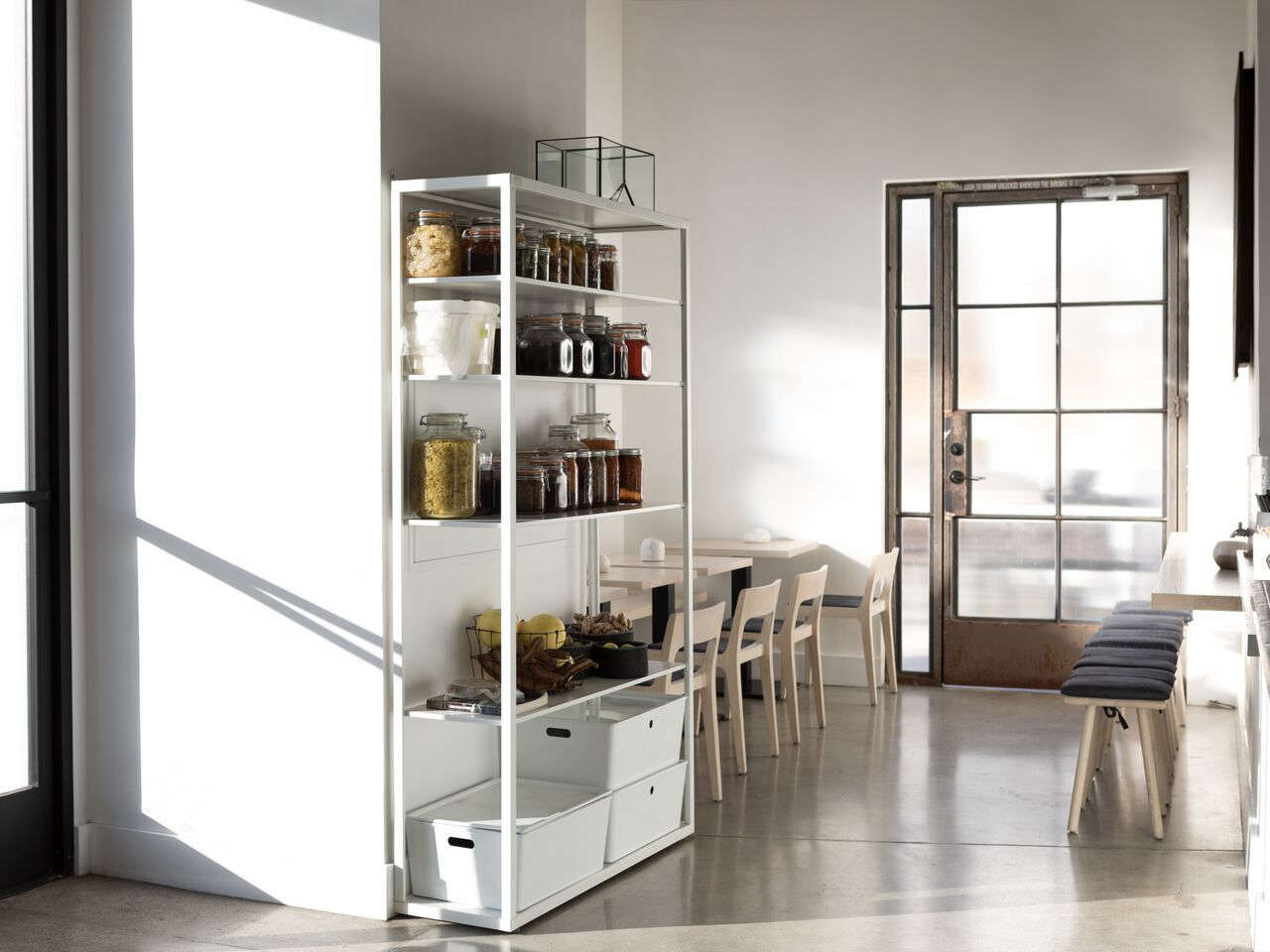 Light floods the interior via ribbed glass windows and doors.