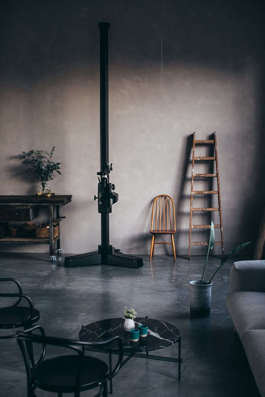 Alongside the kitchen stands Laura’s towering tripod and a living area with a sofa and Black Marble Coffee Table, both by Gubi. Note that the island is on wheels for easy mobility.