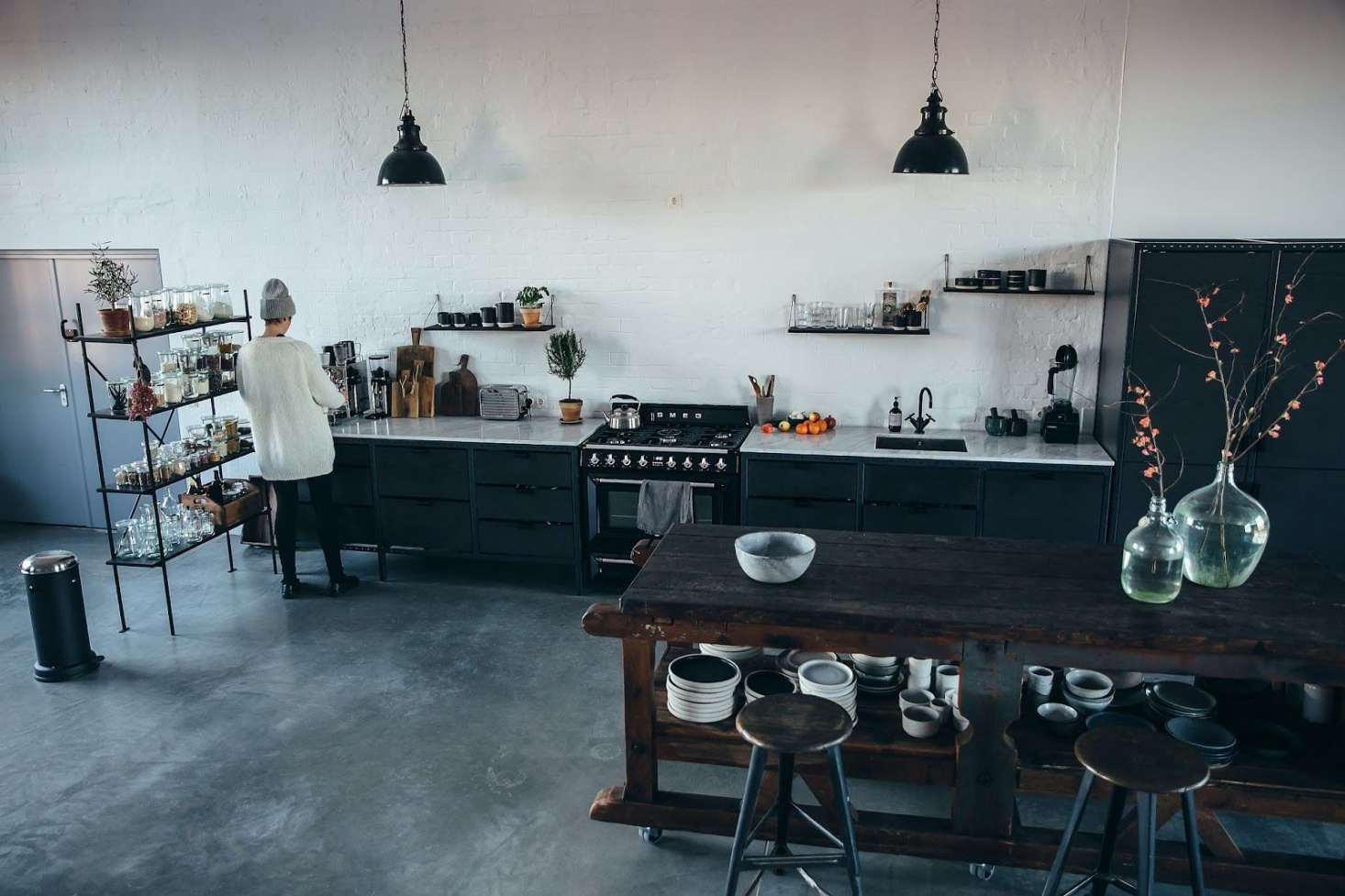 For their kitchen island, Nora and Laura selected a large, old workbench that, like most of the vintage pieces in the loft, came from J & V, their favorite Berlin salvage shop.