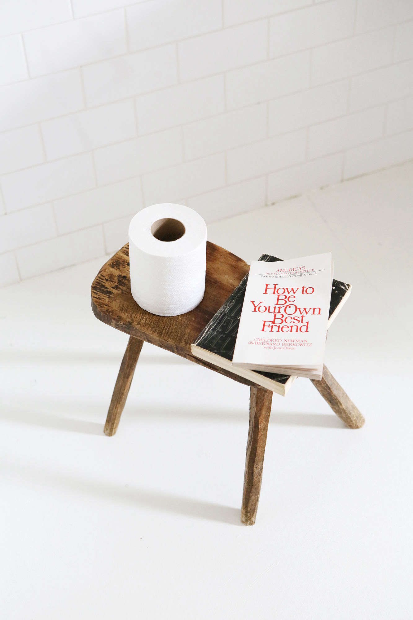 The white-painted flooring has radiant heat. The stool is from John Derian. (See Bathroom of the Week: John Derian