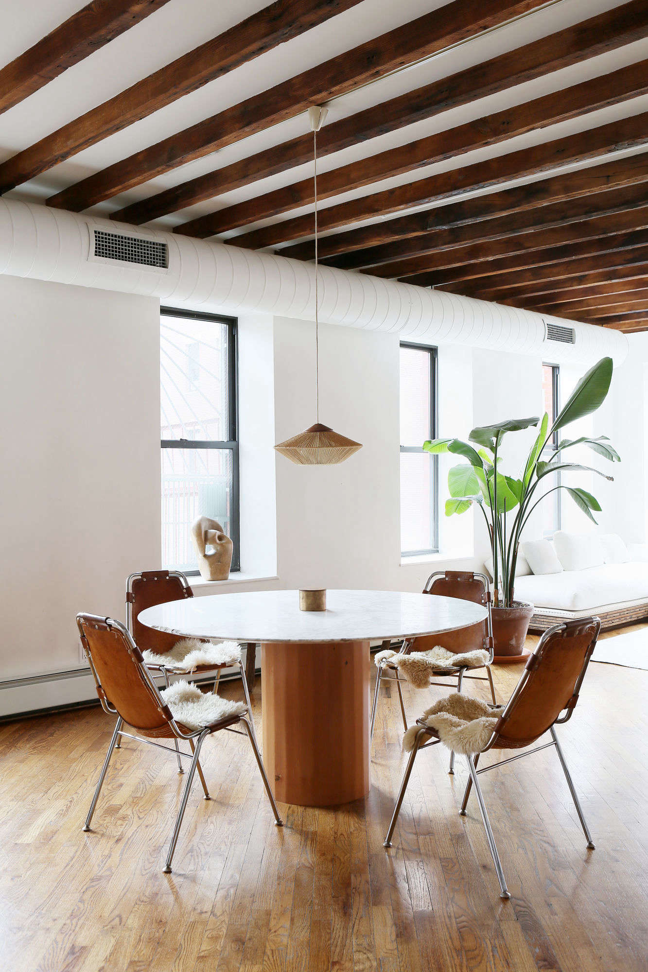 Even the exposed pipes in the loft-style apartment are painted white.