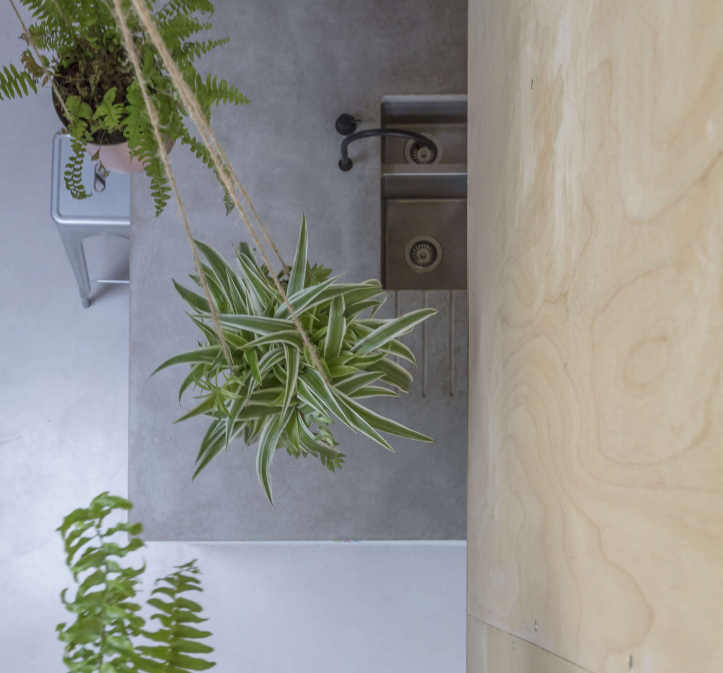 The view from the second-floor study looking down. Note the integrated drain board in the island’s concrete counter.