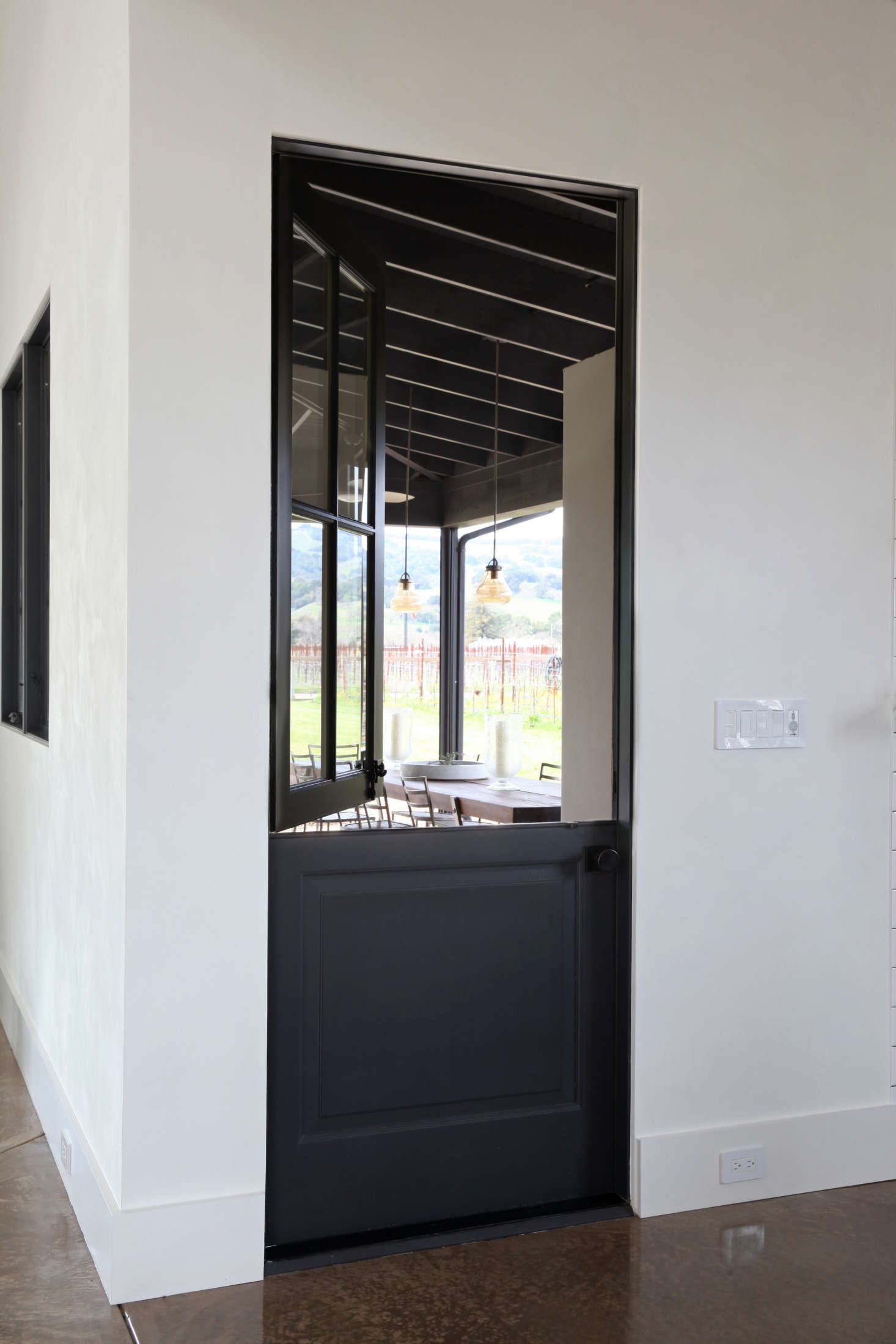 A Dutch door opens to the back dining patio. It