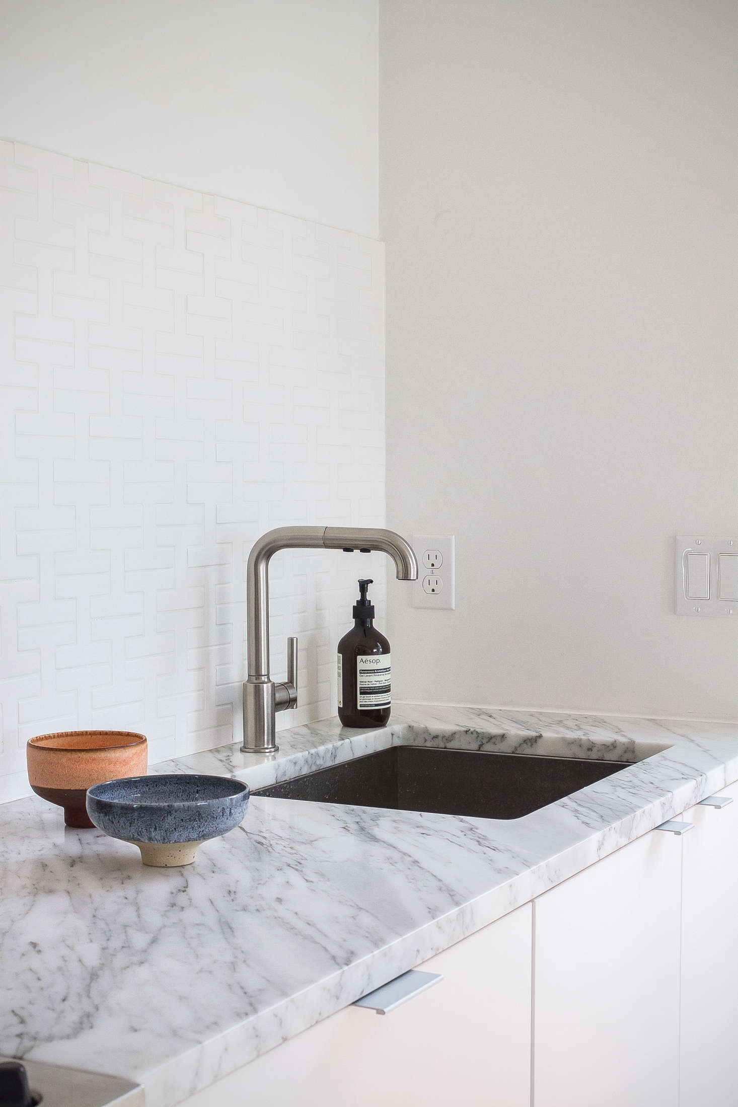 White cabinets meet white walls and a white backsplash in Reader Rehab: A Boston Kitchen Embraces the Light.