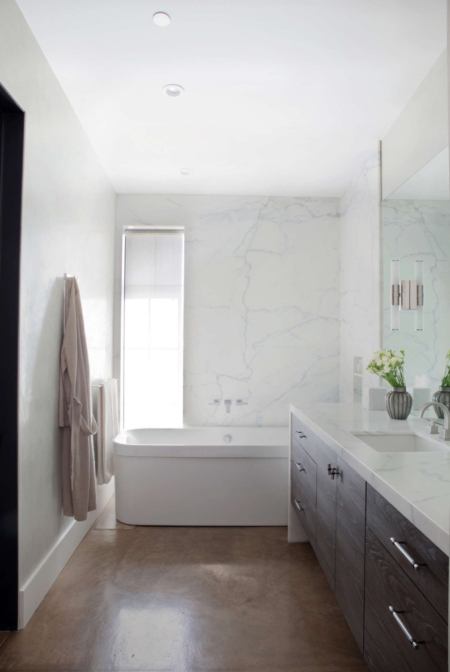 The walls in the master bathroom are waxed Venetian plaster by Willem Racké Studio in San Francisco. The countertop and shower surround is Calacatta Oro.