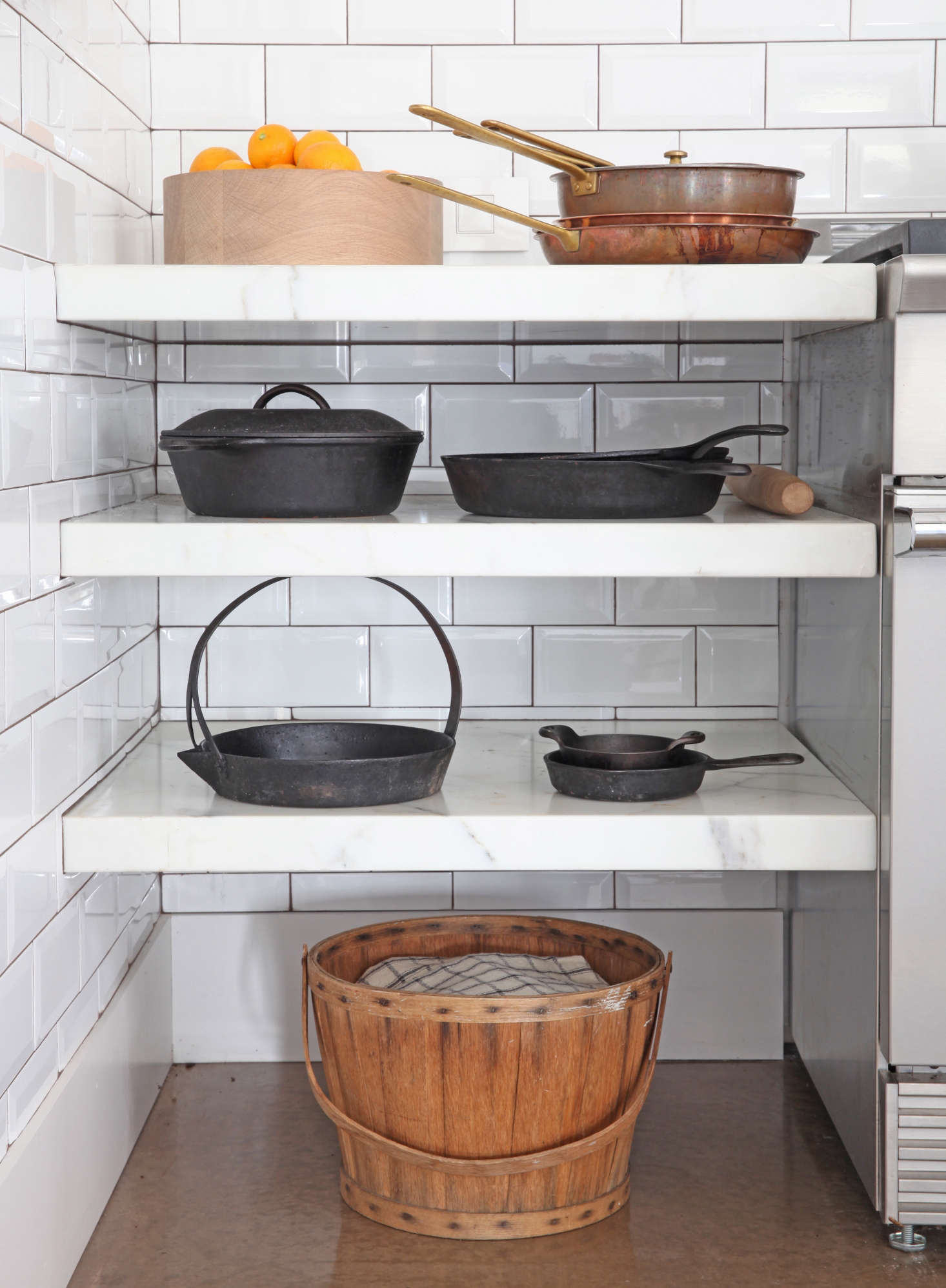 The duo saved money by choosing low-cost, beveled white subway tile for the kitchen walls.