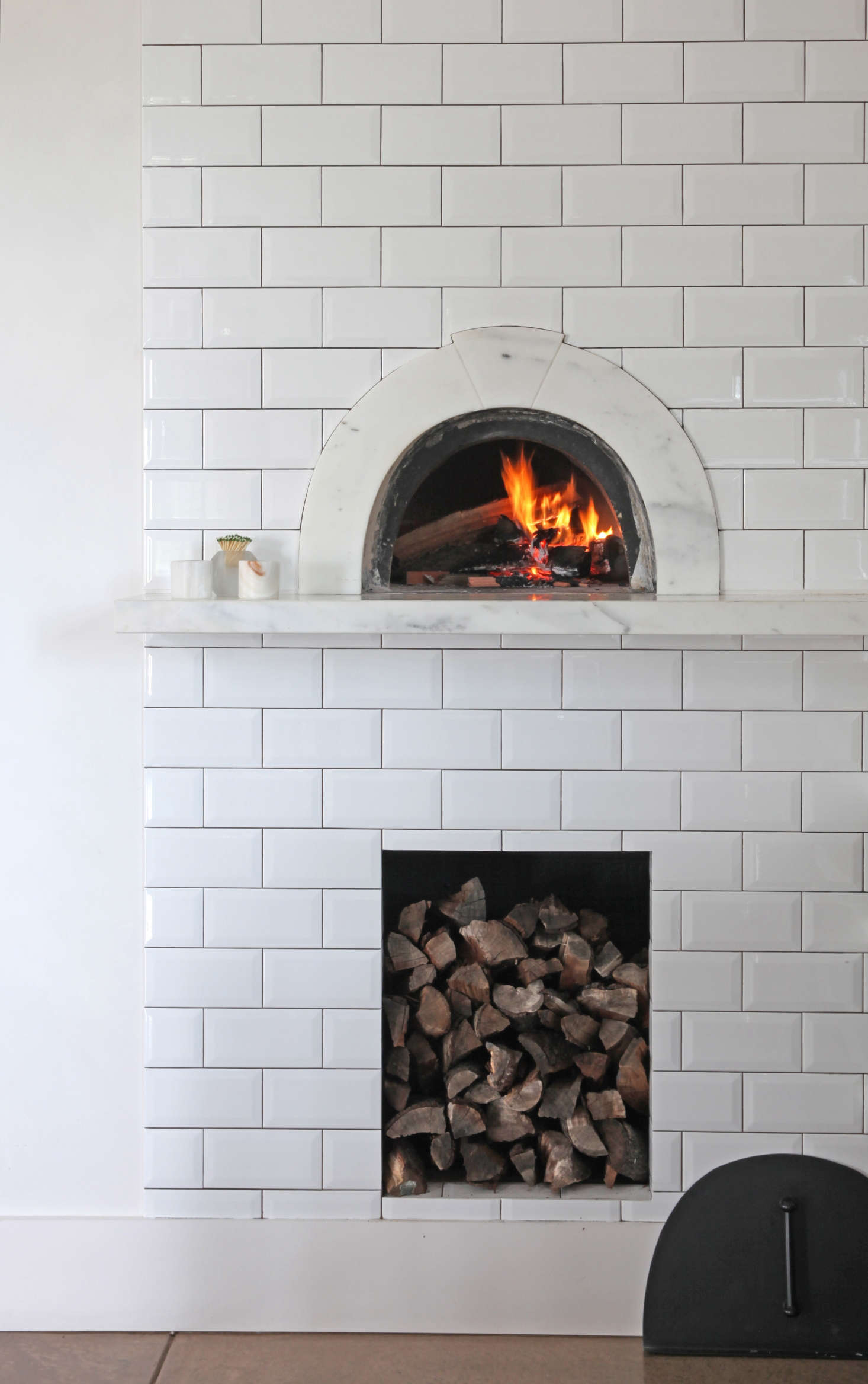 The pizza oven is from Wildwood Ovens in Los Angeles, and the marble surround with keystone detail was designed by Belinda. The pair stores chopped almond wood beneath the pizza oven; Gail orders it by the cord from a Bay Area company that supplies local restaurants.