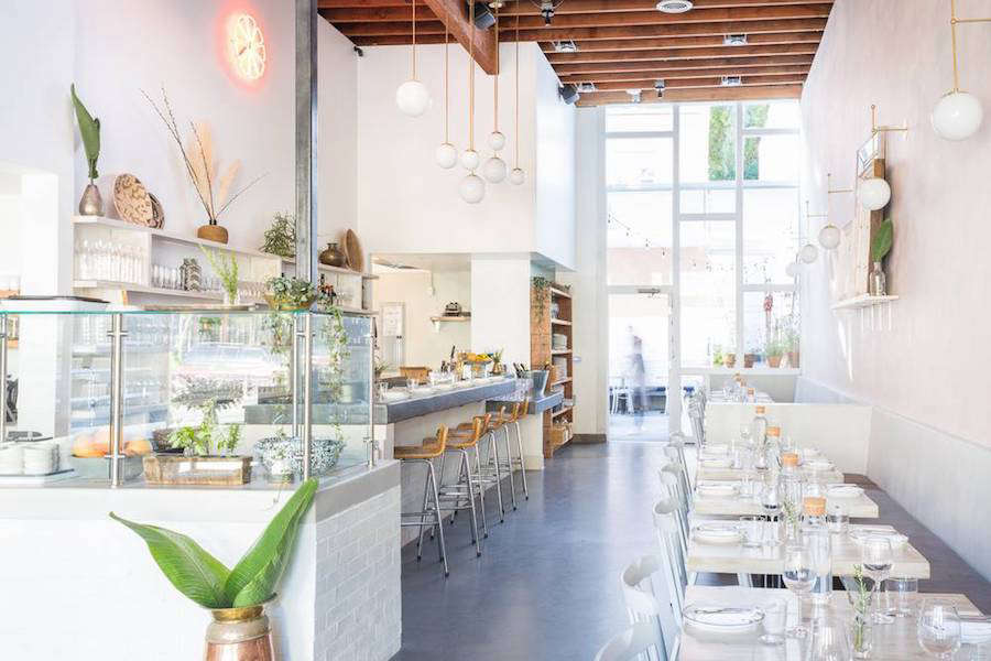 The interior, with concrete flooring and a new floor-to-ceiling glass wall.