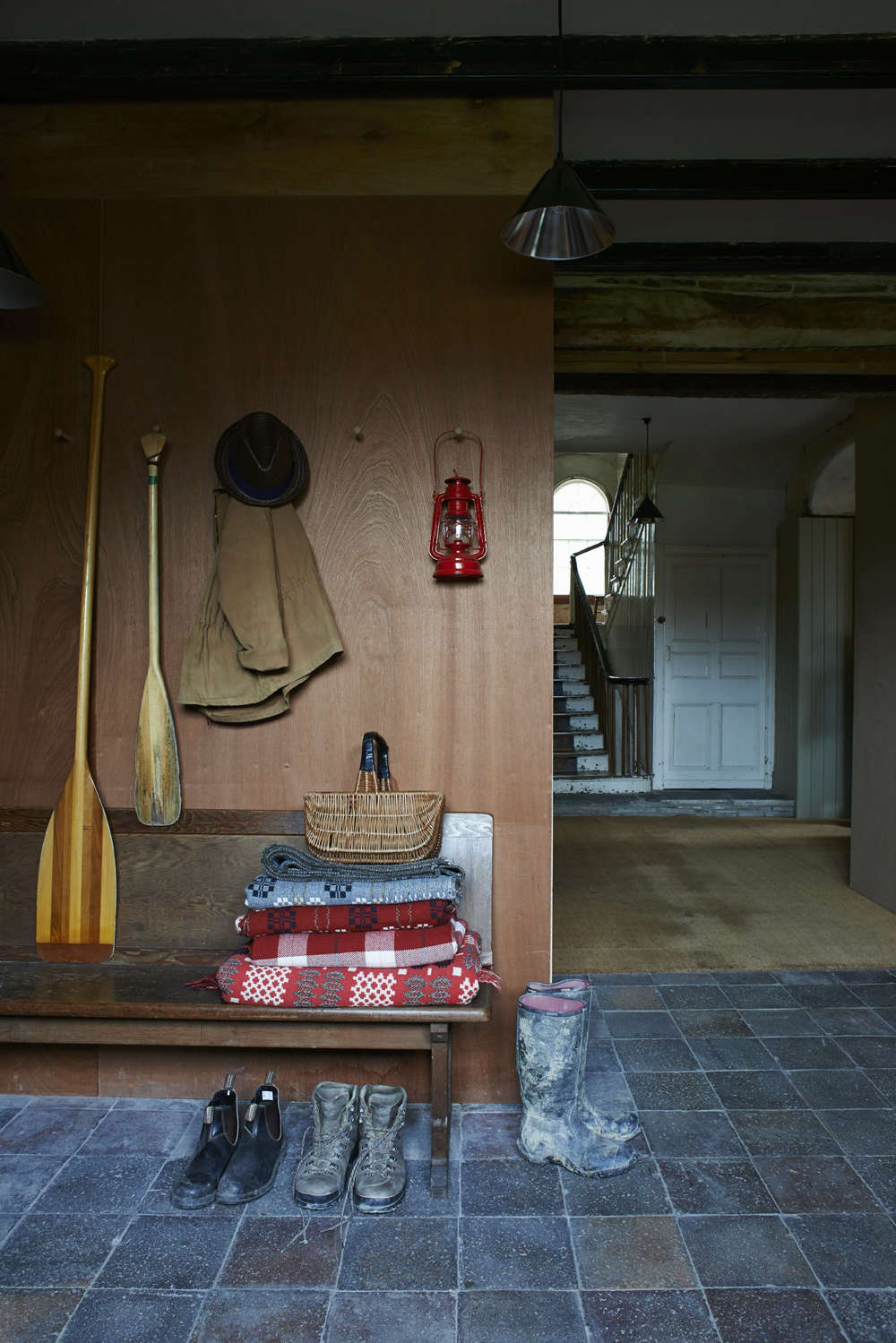 Stacked woolen blankets in the mudroom at FForest: A Former Farm Transformed into the Ultimate Welsh Country Retreat.
