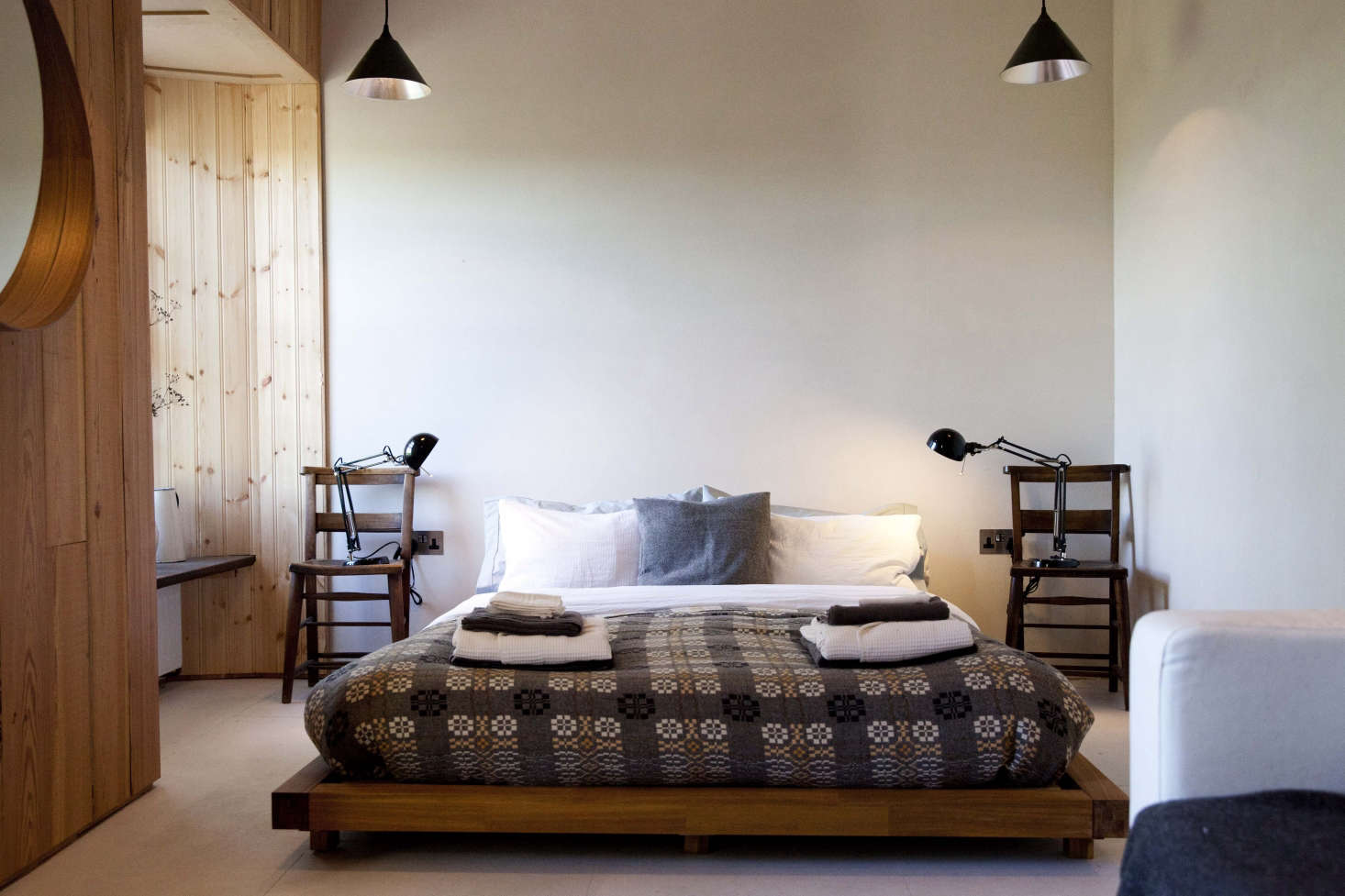 Traditional wool blankets by iconic mill Melin Teifil covers the beds in FForest: A Former Farm Transformed into the Ultimate Welsh Country Retreat.