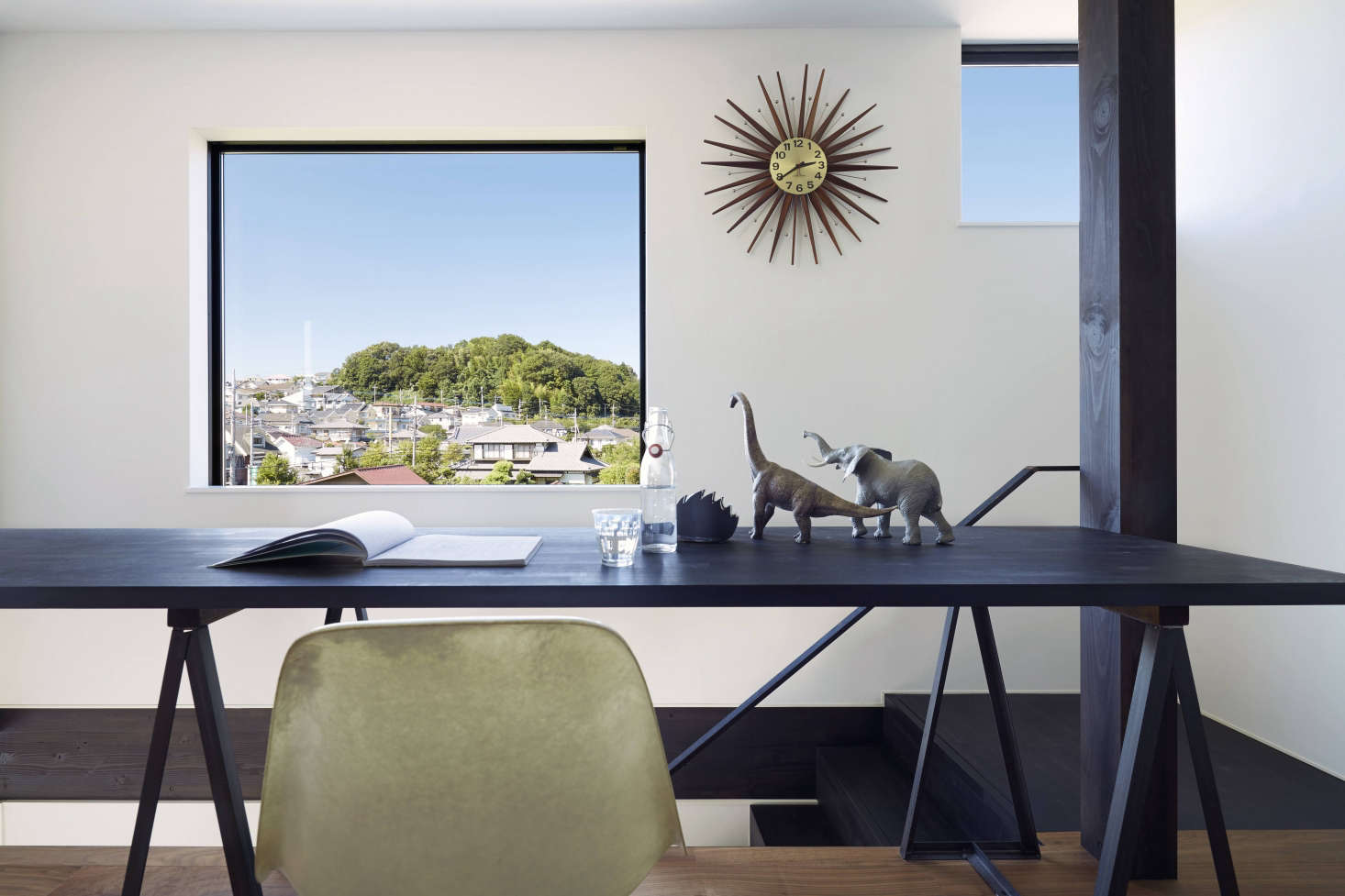 The space off the stairs serves as a study and bedroom for the kids. By day, it