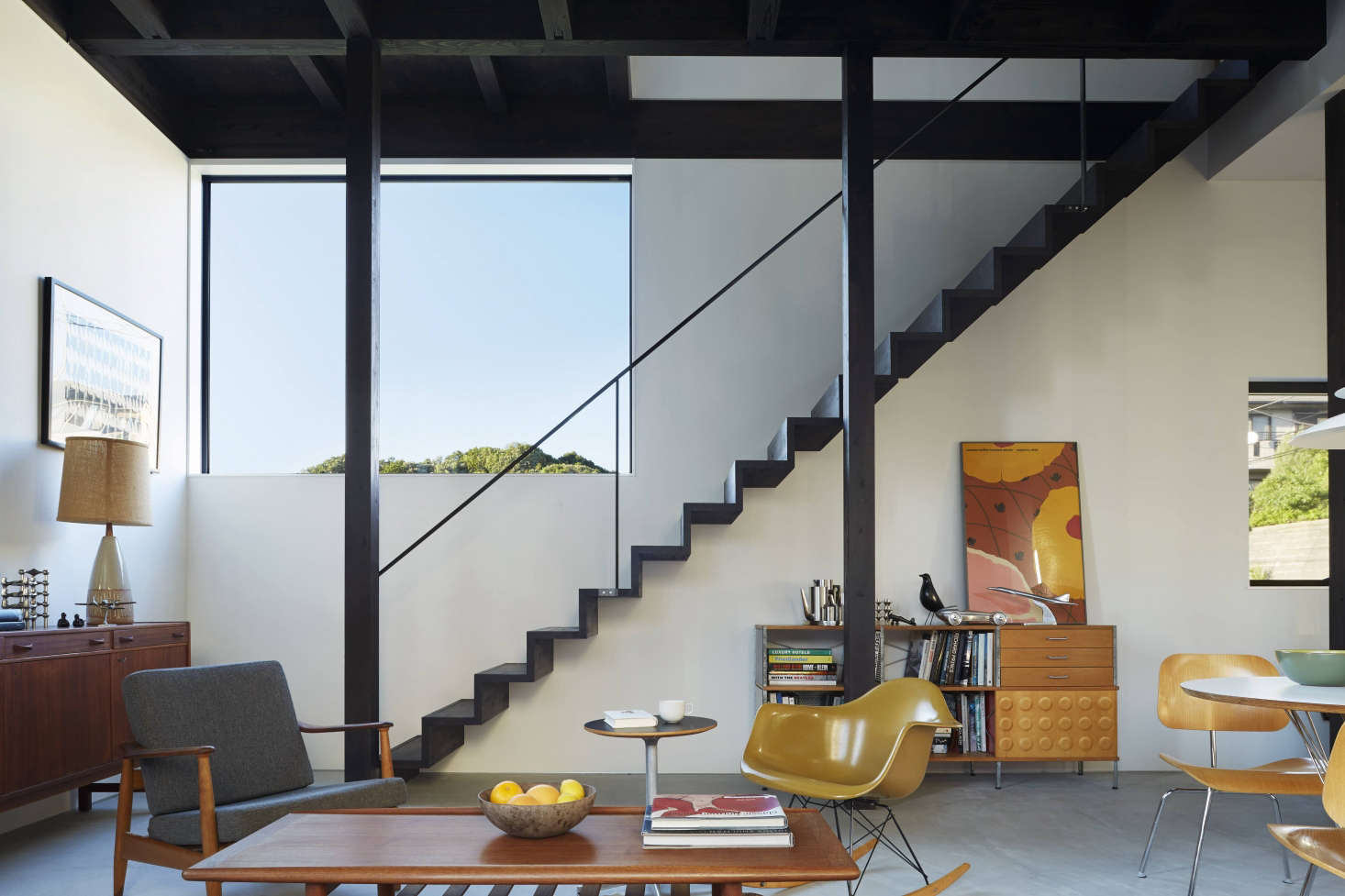 Floating stairs with an open rail—something permitted in Japan and encouraged by the owners—serve as a sculptural presence in the space.