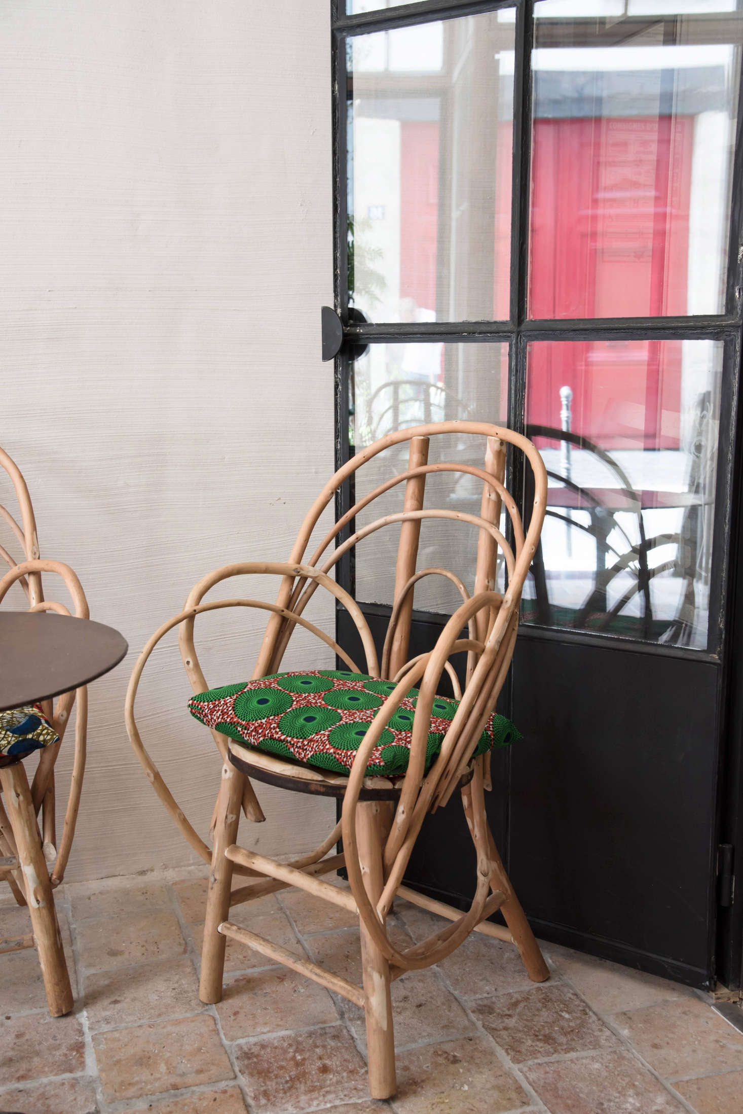 Vintage caned chairs, brought indoors, convey garden ease. Similar styles are available on Etsy.