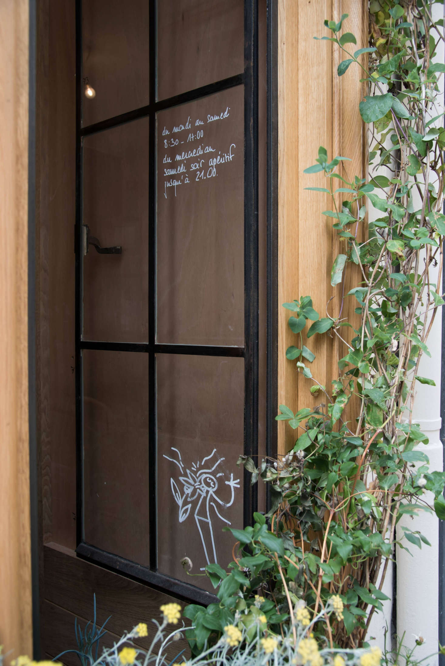 Steel-frame windows double as handwritten signs—and a place for quirky, almost hidden doodles by Paris-based artist YAK.