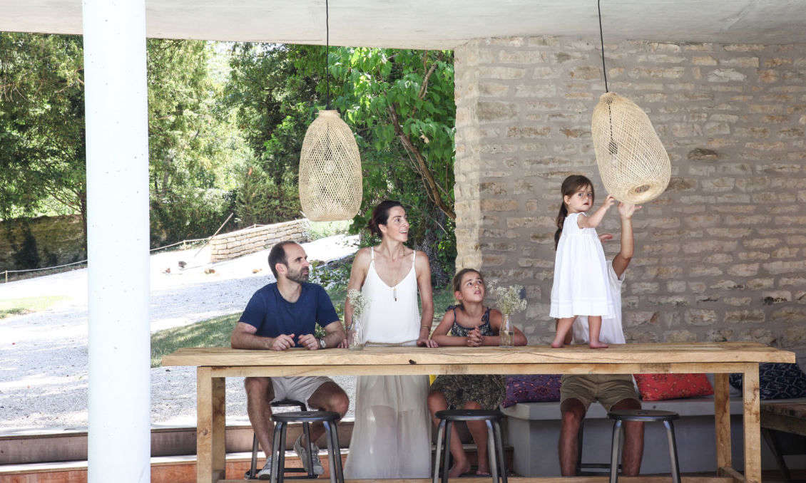 Interior designer Clarisse Prudent, her husband, Antoine, and their three children live in a converted stable in Dijon, Burgundy. Note the original stone wall in the background.