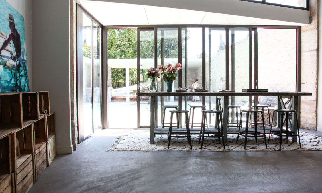 The kitchen table overlooks its open-air counterpart.